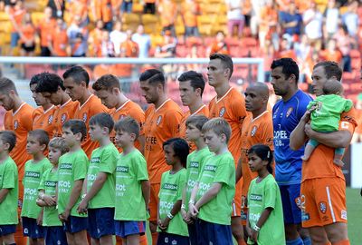 The Brisbane Roar hang their heads in silence before their A-League match.