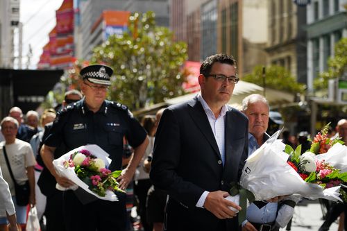 Premier Daniel Andrews and Chief Commissioner Graham Ashton lay flowers at the scene in 2017.