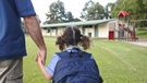 Rear view of schoolgirl holding her fathers hand on the way to school. Real people. Copy space