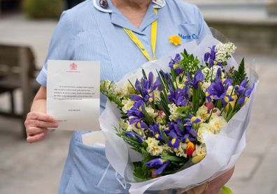 General view of flowers from Queen Elizabeth II to staff at St Bartholomew's Hospital, London, on the anniversary of the first national lockdown to prevent the spread of coronavirus. (Photo: March 23, 2021)