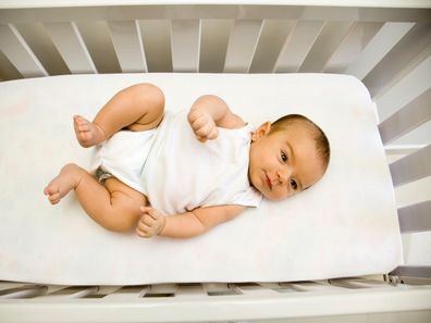 Newborn in cot