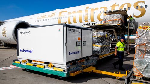 Container holding the AstraZeneca COVID-19 vaccine is removed from the Emirates airlines plane as the first vaccination doses into the country arrives at Sydney International airport. 