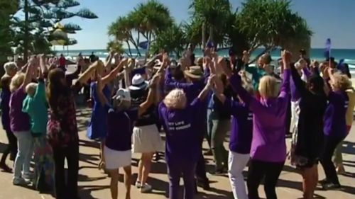 Participants donned purple and danced to the Bon Jovi classic, "It's My Life". (9NEWS)