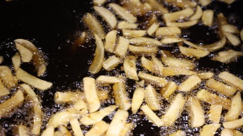 Potato chips cook in a deep fryer at a fish and chip shop on May 1, 2022 in London, England. The war in Ukraine is causing a shortage of sunflower oil. (Photo by Hollie Adams/Getty Images)