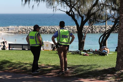 Police officers are seen patrolling Cottesloe Beach on April 10, 2020 in Perth, Australia.