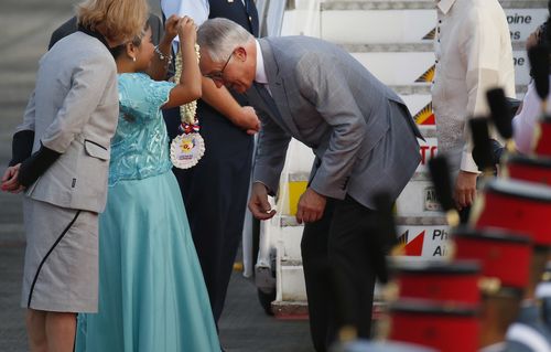 Mr Turnbull receives a lei after his arrival in Manila. (AAP)