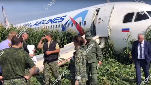 Video footage released by the Russian Investigative Committee shows investigators near the Ural Airlines A-321 passenger plane on the site of its emergency landing in a field. 