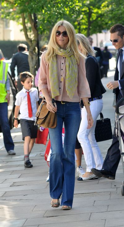 Coachella-worthy flared denim jeans and a pastel scarf are supermodel Claudia Schiffer's school run edit in Notting Hill.