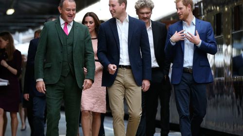 Actor Hugh Bonneville walks with the Duke and Duchess of Cambridge, Simon Farnaby and Prince Harry as they arrive at Paddington Station. (AAP)