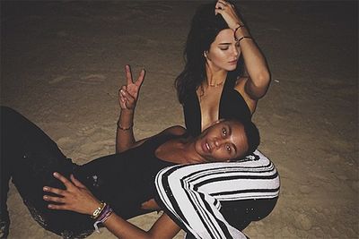 Kendall and her pal demonstrate the best way to not get burnt on the beach… night swimming! Or, at least, night "sanding". <br/><br/>Yeah, we're not quite sure what's going on there, but we do know that no fair Jenner skin was harmed in the making of this image. <br/><br/>Instagram @kendalljenner