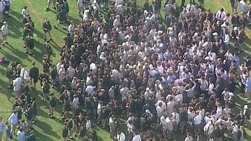 Hundreds of students gathered on the school oval to protest the sacking of Mr Brown. (9NEWS)
