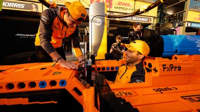 Daniel Ricciardo, McLaren, and Lando Norris, McLaren, with a Lego F1 car.