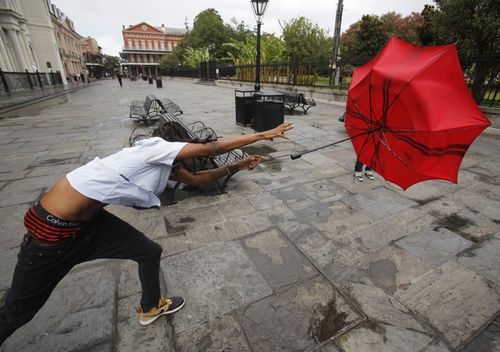 A man in the French Quarter plays with his umbrella in the wind of Tropical Storm Barry in New Orleans, Louisiana, USA.