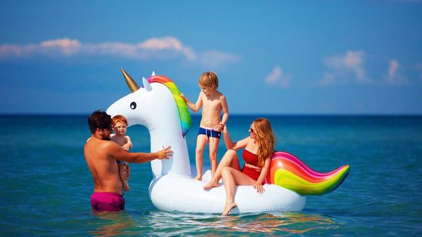 Family on unicorn inflatable