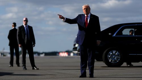 President Donald Trump points after arriving at Palm Beach International Airport on Air Force One, Friday, Jan. 16, 2026, in West Palm Beach, Fla. (AP Photo/Julia Demaree Nikhinson)