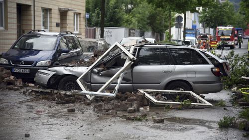 Debris showered down on cars outside the building. Picture: AP/AAP