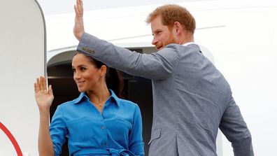 Meghan Markle and Prince Harry wave as they board plane during Australia and Pacific Islands Royal Tour in November 2018