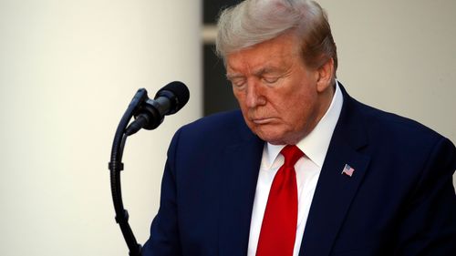 President Donald Trump closes his eyes as he prays during a White House National Day of Prayer Service in the Rose Garden of the White House, Thursday, May 7, 2020, in Washington. (AP Photo/Alex Brandon)