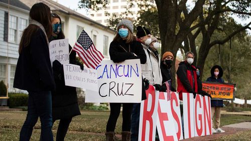 Protesters line the streets outside Ted Cruz's home demanding his resignation.