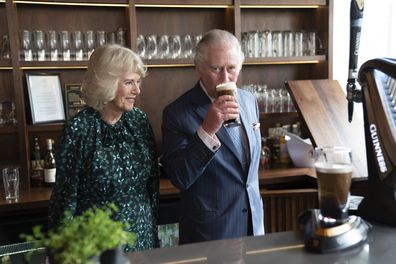 The Prince of Wales sips Guinness during a visit with Camilla, Duchess of Cornwall to the Irish Cultural Centre to celebrate the Centre's 25th anniversary in the run-up to St Patrick's Day 