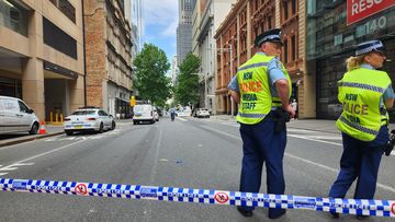 Police tape off a street following a shooting outside law offices on Castlereagh Street in Sydney