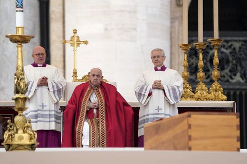Pope Francis sits by the coffin of late Pope Emeritus Benedict XVI St. Peter's Square during a funeral mass at the Vatican, Thursday, Jan. 5, 2023. Benedict died at 95 on Dec. 31 in the monastery on the Vatican grounds where he had spent nearly all of his decade in retirement. (AP Photo/Andrew Medichini)