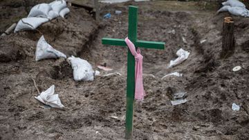  A green cross stands above an abandoned military vehicle position where locals buried four people, on April 5, 2022 in Bucha, Ukraine. The Ukrainian government has accused Russian forces of committing a &quot;deliberate massacre&quot; as they occupied and eventually retreated from Bucha, 25km northwest of Kyiv. Dozens of bodies have been found in the days since Ukrainian forces regained control of the town. (Photo by Alexey Furman/Getty Images)