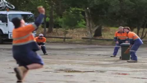 Tradies enjoy a game of cricket after work.