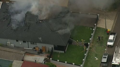 Several people have been treated for smoke inhalation after the blaze gutted the Villawood house. (9NEWS)