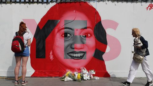 People pass a mural as Ireland goes to the polls to vote in the referendum on the 8th Amendment of the Irish Constitution. Picture: PA