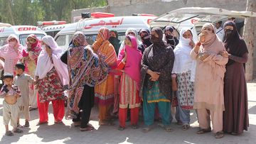 Distraught relatives of the victims wait to receive their bodies. (AAP)