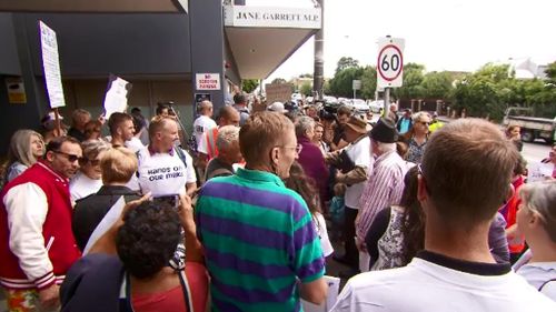 Protesters gathered outside Jane Garrett's electoral office, saying raw milk should be regulated not banned. (9NEWS)