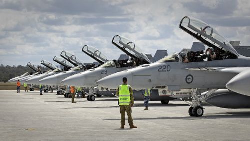 Ground crew assist as RAAF F/A-18F Super Hornets prepare for departure to the Middle East. (ADF)