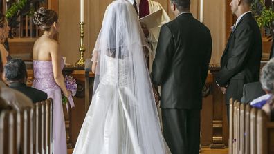 Bride and groom standing at altar during wedding ceremony