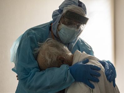 Doctor embraces patient in hospital during the coronavirus pandemic in the United States.