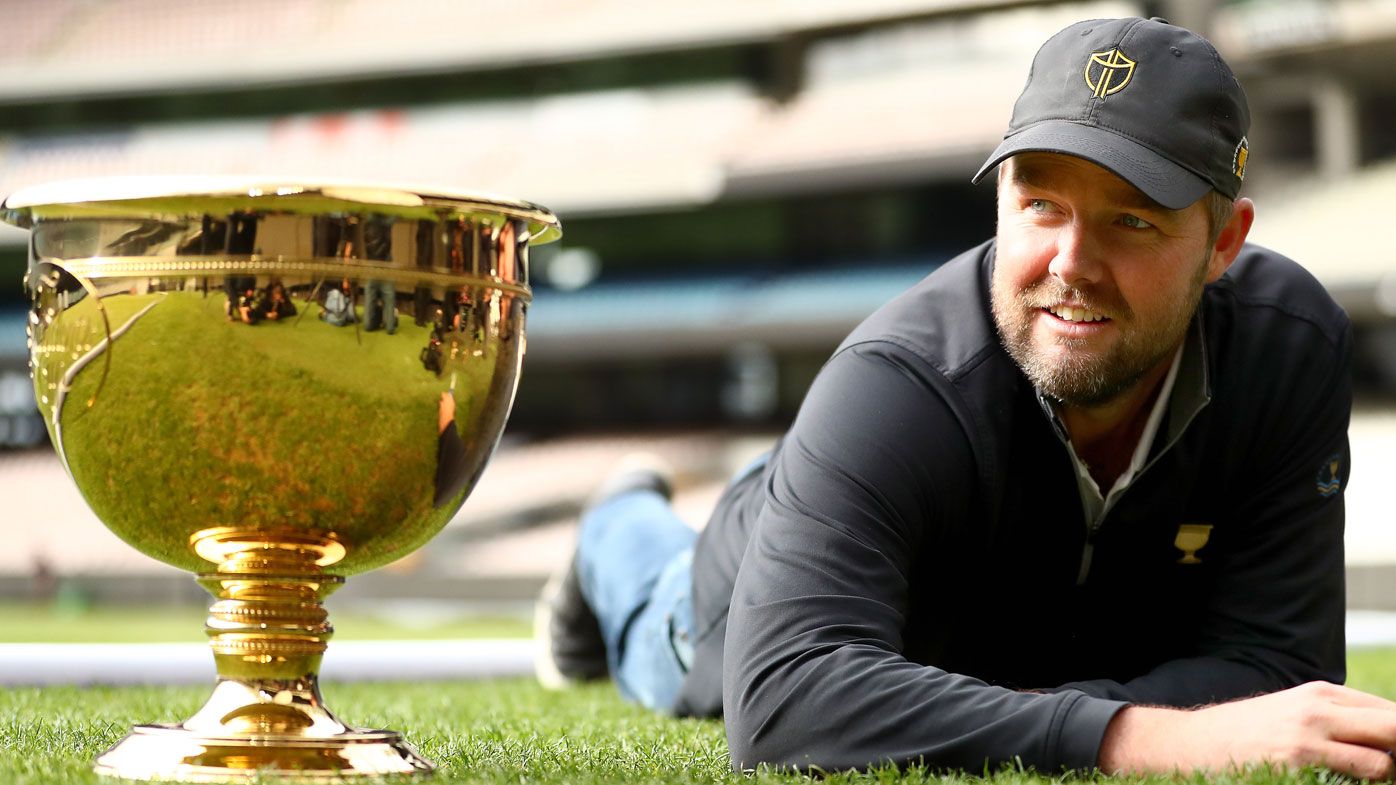 Marc Leishman cuts the grass on the MCG ahead of the 2019 Presidents Cup