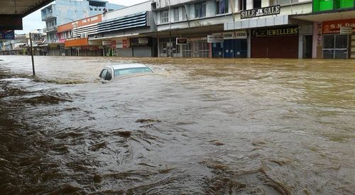 Photos posted on social media from locals shows cars and shops under metres of water. (Facebook)