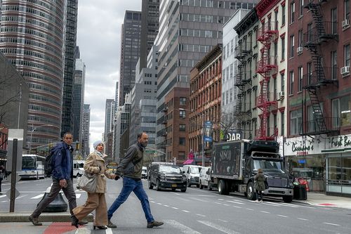 Pedestrians cross the street in New York on Friday, April 5, 2024.
