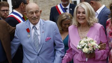US WWII veteran Harold Terens, 100, left, and Jeanne Swerlin, 96, arrive to celebrate their wedding at the town hall of Carentan-les-Marais, in Normandy, northwestern France