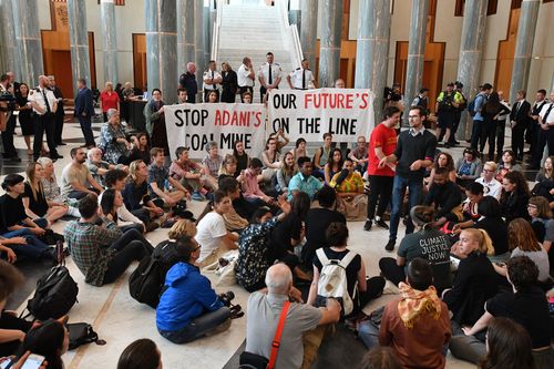 Students set up a peaceful protest on the marble floors of parliament to address the climate change issue with the prime minister.