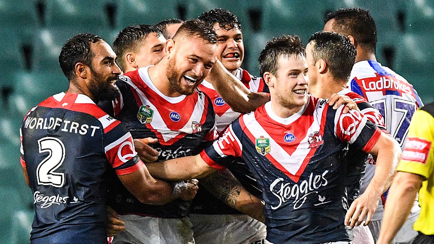 Jared Waerea-Hargreaves (centre) of the Roosters celebrates a try