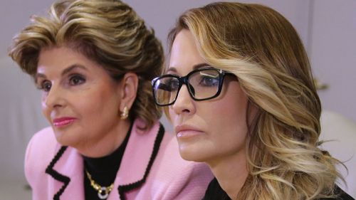 Jessica Drake (R) listens to questions after giving a statement in which she alleges Republican Presidential candidate Donald Trump sexually harassed her at a 2006 golf event in Lake Tahoe at a press conference held by attorney Gloria Allred in Los Angeles, California. (AAP)