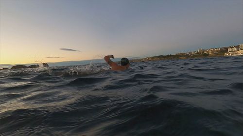 Man breaks record for number of laps swum at Bondi Beach for mental health awareness.