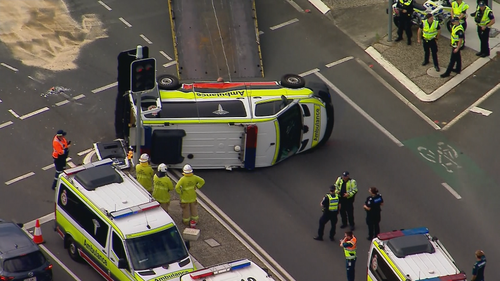 Four people were injured when an ambulance rolled over in Brisbane this morning.