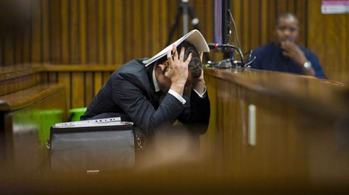 Oscar Pistorius grabs his head in shock as images of a bloodied Reeva Steenkamp are shown at his murder trial in Pretoria High Court. (Getty)