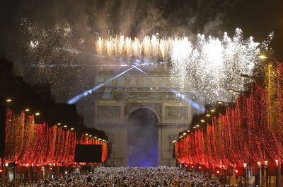 Fireworks illuminate the sky over the Arc de Triomphe during the New Year's Day celebrations on the Champs Elysees, in Paris.