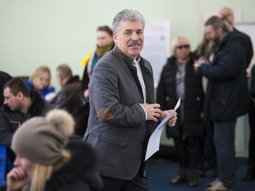 Communist party candidate Pavel Grudinin casting his vote in the election. (AAP)