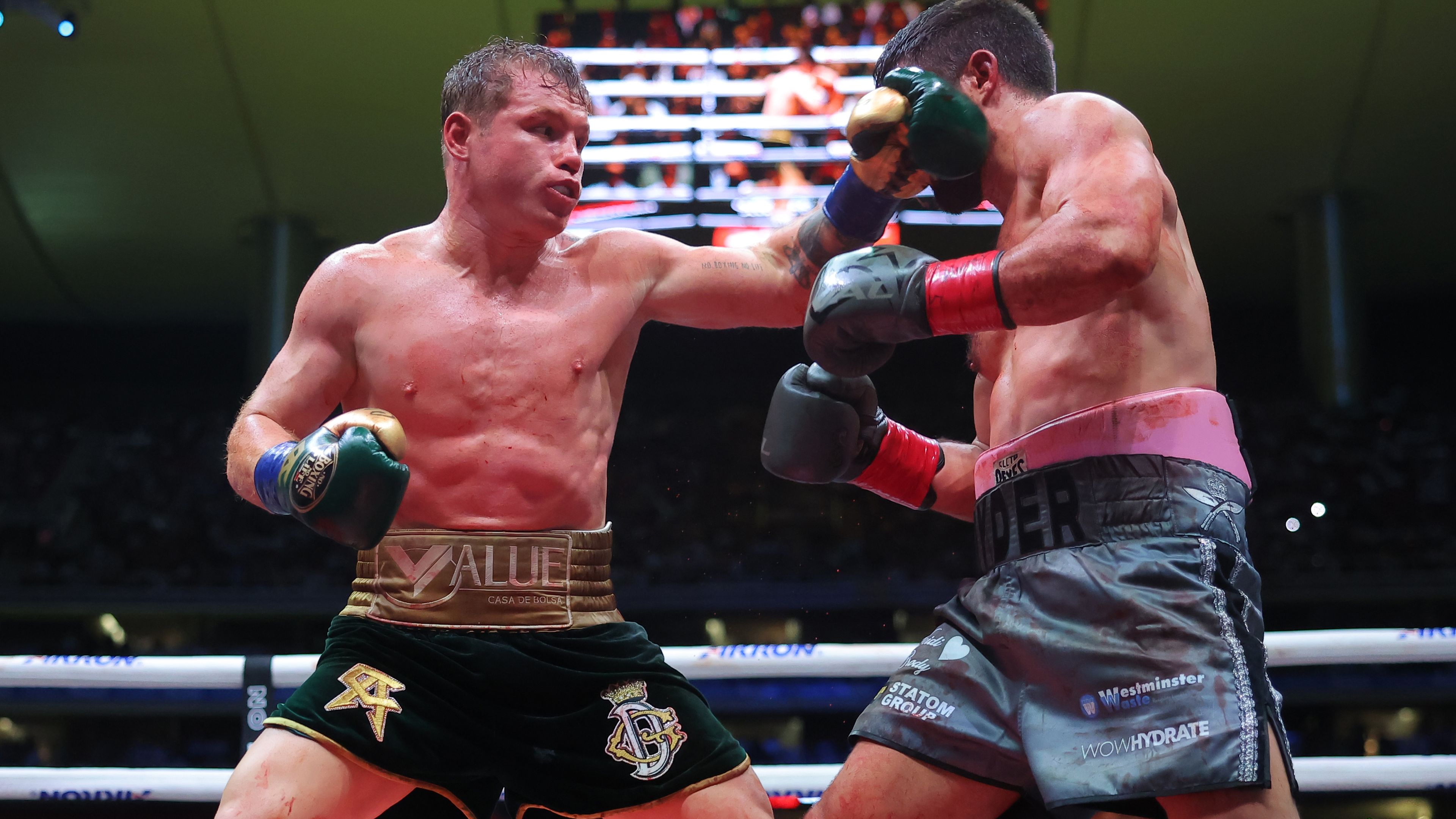 Canelo Alvarez of Mexico punches John Ryder of Great Britain.