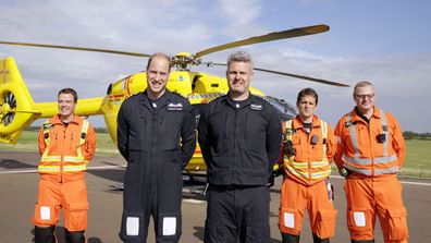 Britain's Prince William, the Duke of Cambridge, second left smiles, as he poses for a photo with colleagues before starting his final shift with the East Anglian Air Ambulance based out of Marshall Airport, near Cambridge, England, Thursday, July 27, 2017