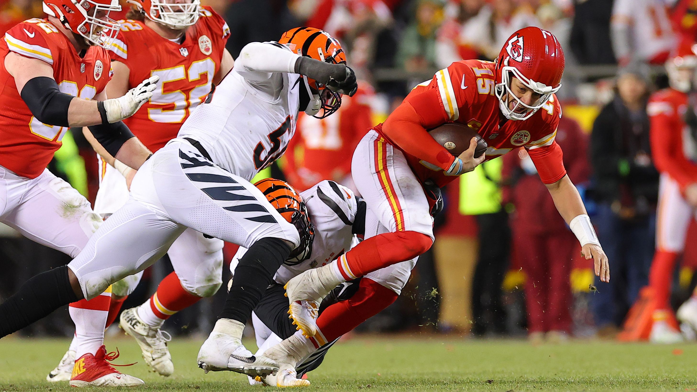 Joseph Ossai and Zach Carter of the Cincinnati Bengals tackle Patrick Mahomes of the Kansas City Chiefs during the fourth quarter in the AFC championship game.